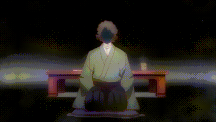 a man in a green kimono is kneeling down in front of a table in a dark room .