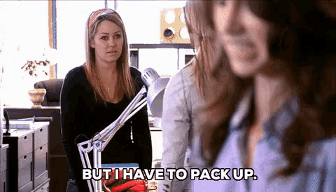 a woman standing next to a lamp says but i have to pack up
