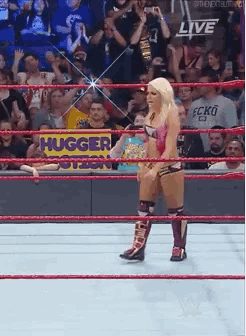 a wrestler in a ring with a sign that says hugger on it
