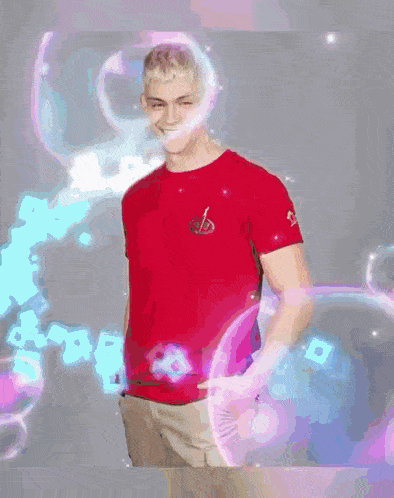 a man in a red shirt and khaki pants is standing in front of a bubble .