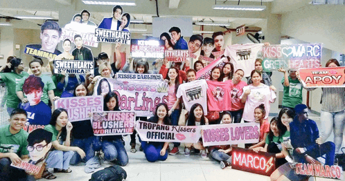a group of people holding signs for kisses lovers and sweethearts