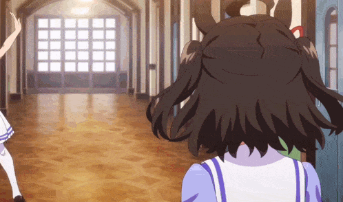 a girl with pigtails is standing in a hallway with other girls
