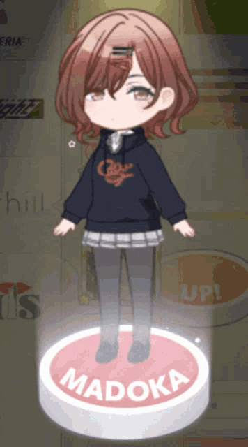 a little girl is standing on a red button that says madoka on it