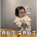 a little girl is sitting at a table holding a bottle of milk .