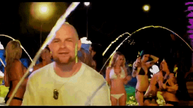 a man in a white shirt is standing in front of a fountain