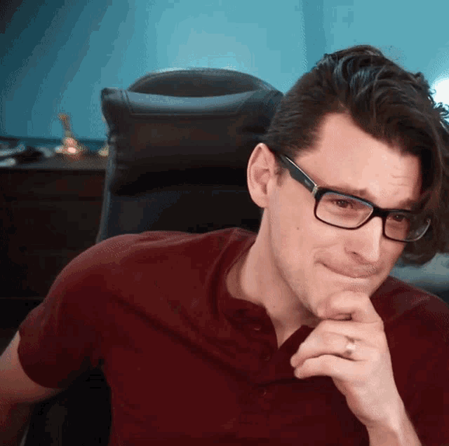 a man with glasses and a ring on his finger