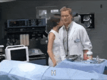 a doctor and a woman kissing in a hospital room