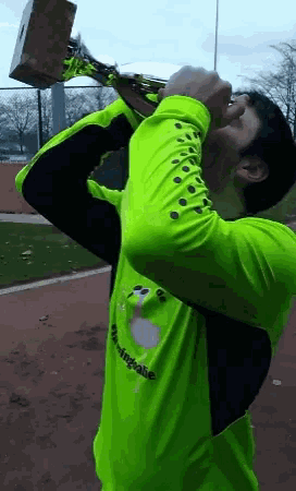 a man wearing a neon green shirt with the word winning on it