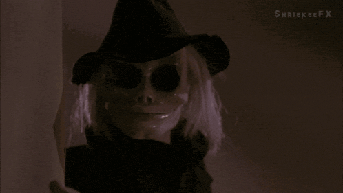 a skeleton holding a knife in a dark room with shrinkeefx written in the corner