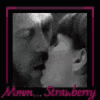 a black and white photo of a man and a woman kissing