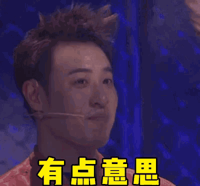 a man with a microphone in his mouth is smiling and has chinese writing on his face .