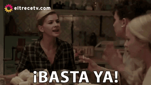 a group of women sitting at a table with the words basta ya written in white