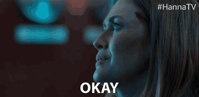 a close up of a woman 's face with the word okay above her
