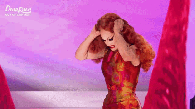 a drag queen is holding her hair in front of a pink background that says drag race