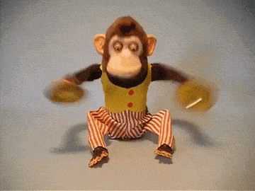 a stuffed monkey is sitting on a table with the word one behind it