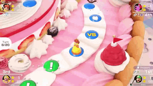 a video game is being played on a table with a pink cake in the background