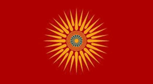 a red flag with a yellow sun and a blue center on it .