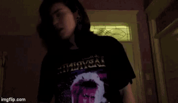 a woman wearing a t-shirt that says ' immortal ' on it