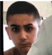 a close up of a person 's face with a shaved head .