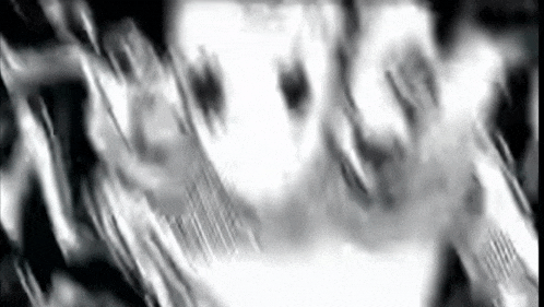 a black and white photo of a person 's face with a blurred background