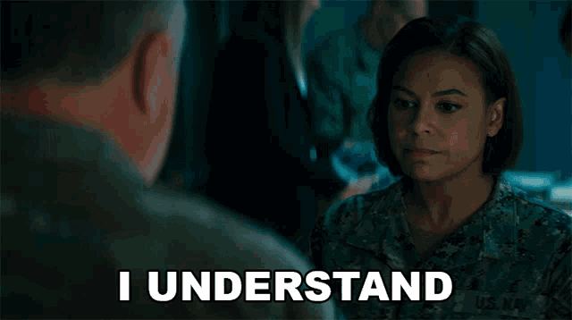 a woman in a us navy uniform is talking to a man and says i understand