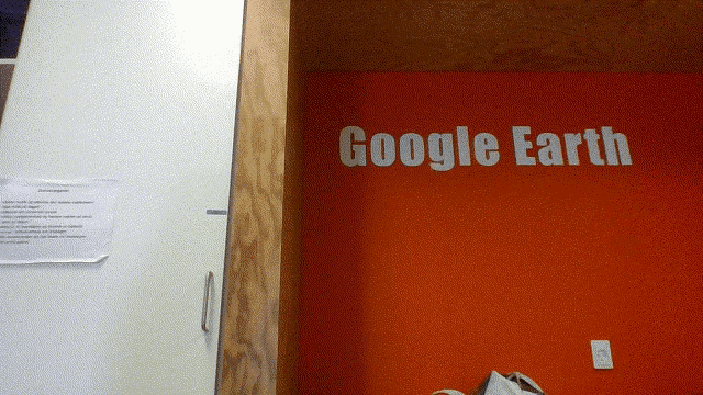 a red wall with the words google earth written on it