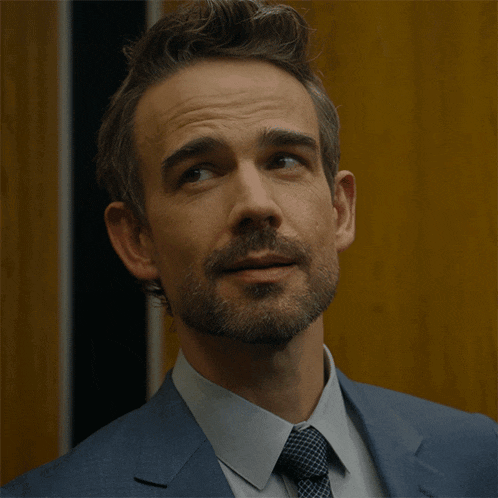 a man with a beard in a suit and tie