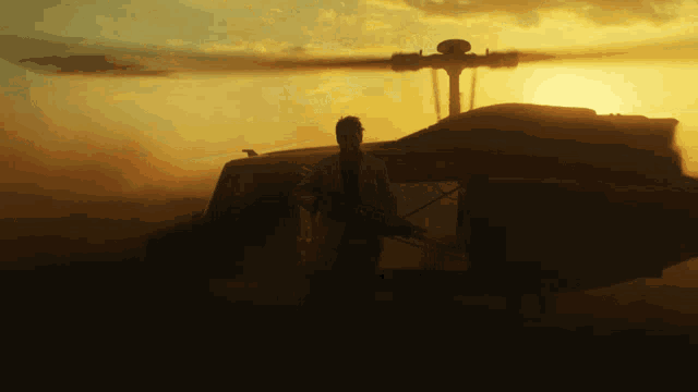 a man standing in front of a helicopter with a gun