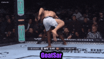 a ufc fighter is being lifted in the air by another fighter