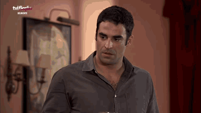 a man stands in front of a tv which says tvi