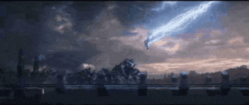 a person is flying through the air with a lightning bolt coming out of their hand .
