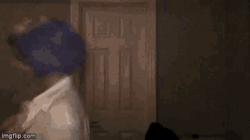 a blurry picture of a person wearing a blue hat and a white robe .