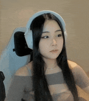a woman is wearing headphones and sitting in a chair .