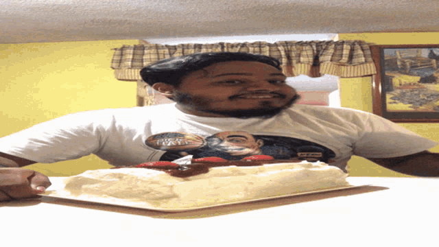 a man wearing a t-shirt that has a picture of a man with a beard