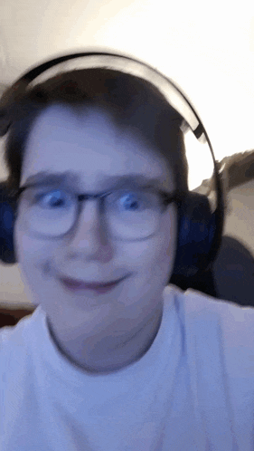 a man wearing glasses and headphones is smiling for the camera