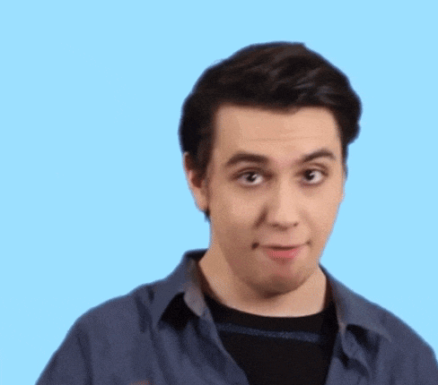 a young man in a blue shirt is making a funny face and clapping his hands .
