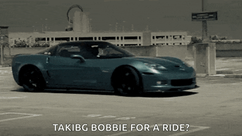 a blue sports car is parked in a parking lot with the words " takibg bobbie for a ride " written below it