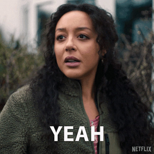 a woman in a green jacket says " yeah " in white letters