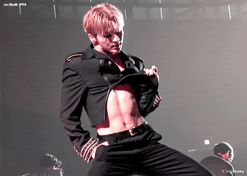 a man in a black suit is dancing on a stage with a watermark that says cn.han.b.yvs