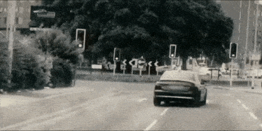 a car is driving down a street with a sign that says openroad