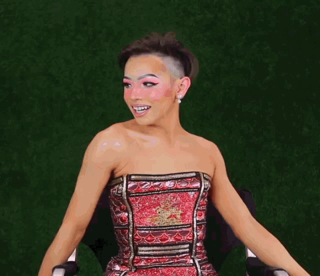 a woman in a red dress is sitting in an office chair