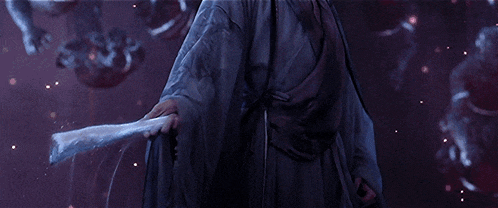 a man in a kimono is holding a white fan in his hand