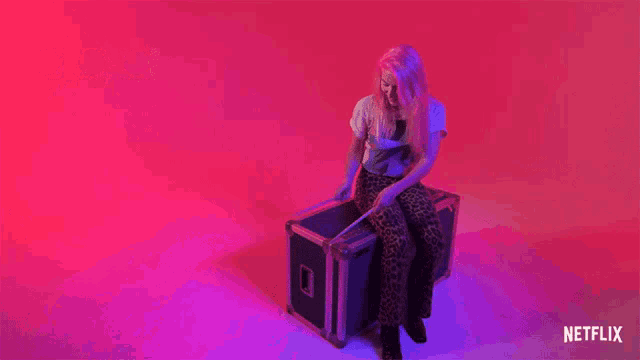 a woman is sitting on a box with the words kick kick snare kick rest kick snare written on it