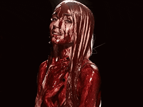 a woman with blood coming out of her face and hands