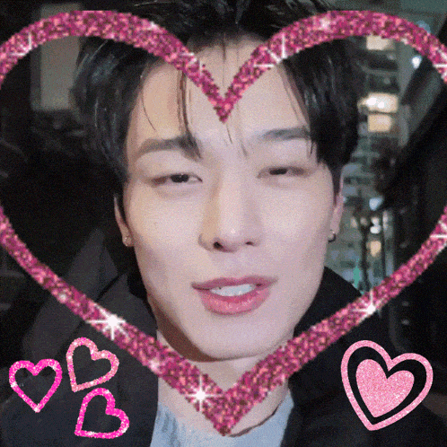 a close up of a man 's face with a heart shaped frame around it