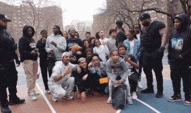 a group of people posing for a picture with one wearing a sweatshirt that says ' ding ding ' on it