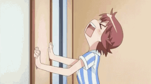 a girl in a blue and white striped shirt is standing next to a door .
