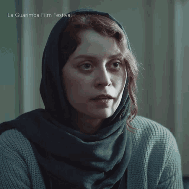 a woman wearing a scarf and a sweater is featured in a la guarimba film festival ad
