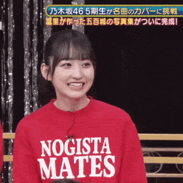 a girl is wearing a red sweater that says nogista mates