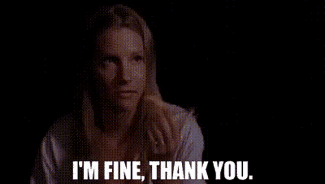 a woman is saying i 'm fine thank you in a dark room .
